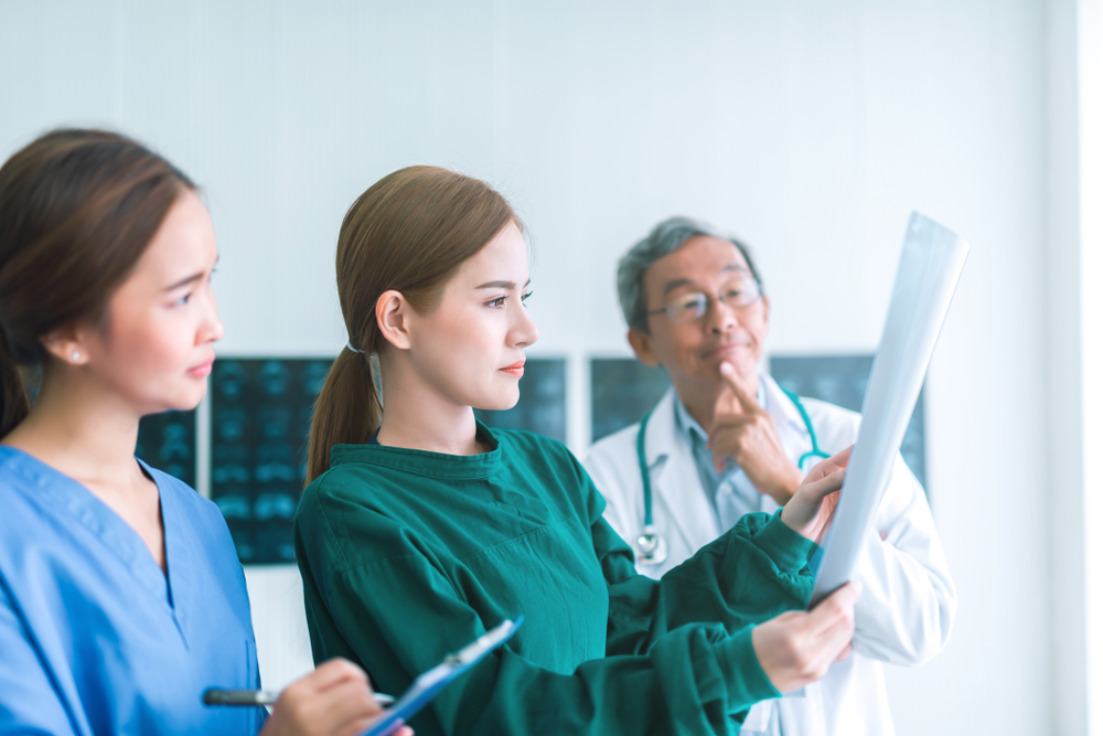 Doctor carefully reviewing MRI results with focused patient